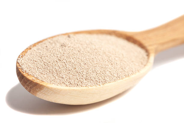close up of wooden spoon with biotin powder